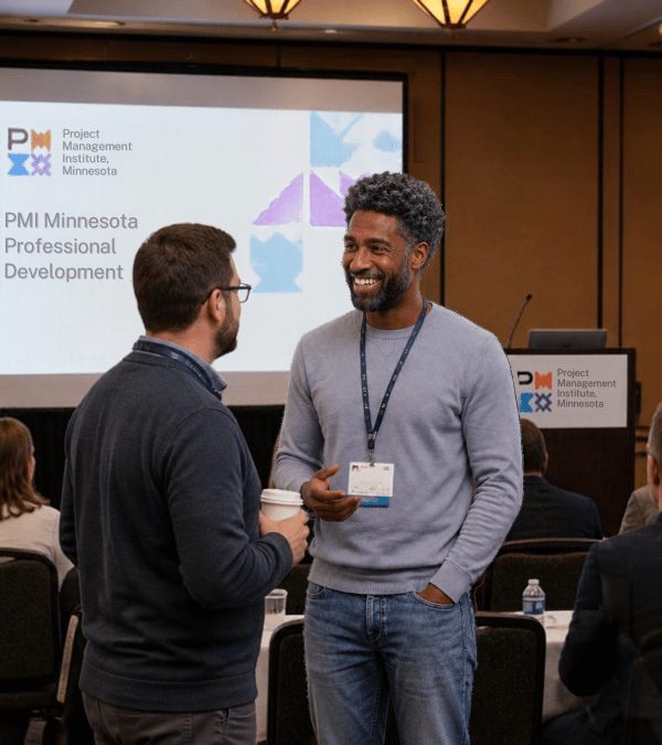 Ahadu Legesse talking with a colleague at a project management professional development event in Minnesota